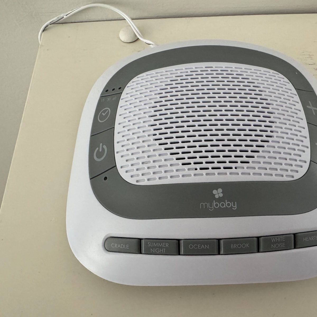 A baby monitor with a mybaby logo, power button, volume control, and sleep mode buttons.